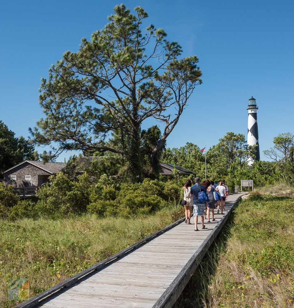 Visitors walk toward the Cape Lookout Lighthouse